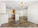 Bright, open-concept living area with an adjacent kitchen and hardwood style floors at 1068 Plaza Walk Dr, Charlotte, NC 28215