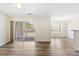 Bright, open-concept living space with a sliding glass door to balcony and hardwood style flooring at 1068 Plaza Walk Dr, Charlotte, NC 28215