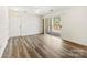 Bright, open-concept living area with sliding glass doors leading to balcony and hardwood style floors at 1068 Plaza Walk Dr, Charlotte, NC 28215