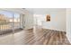 Bright, open-concept living area with sliding glass doors leading to balcony and hardwood style floors at 1068 Plaza Walk Dr, Charlotte, NC 28215
