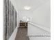 Upstairs hallway with decorative art and console table, leading to other areas of the home at 11343 Magpie Ct # 10, Charlotte, NC 28215