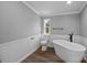 Elegant bathroom featuring a freestanding tub, wood-look flooring, and neutral color palette at 1254 Raxter Rd, Edgemoor, SC 29712