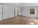 Bedroom with hardwood floors, neutral paint, and access to the modern bathroom at 1254 Raxter Rd, Edgemoor, SC 29712
