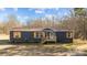Charming single-story home with blue siding, wooden shutters, front porch, and a well-maintained lawn at 1254 Raxter Rd, Edgemoor, SC 29712