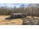 Charming single-story home featuring navy siding, wood shutters, and a wooden porch with steps at 1254 Raxter Rd, Edgemoor, SC 29712