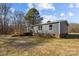 Exterior view of the property showcasing the home's siding, wooden deck and stairs, and a spacious yard at 1254 Raxter Rd, Edgemoor, SC 29712