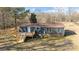 Single-story home featuring navy siding, a brown roof, a wooden deck with stairs, and a brick foundation at 1254 Raxter Rd, Edgemoor, SC 29712