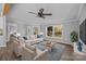Bright living room features modern ceiling fan, hardwood floors, and a beautiful view from the windows at 1254 Raxter Rd, Edgemoor, SC 29712