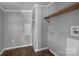 Bright utility room featuring hardwood floors, grey paint, white trim, built in shelving, and washer and dryer hookups at 1254 Raxter Rd, Edgemoor, SC 29712
