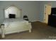 Bedroom featuring a decorative bed frame, neutral carpeting, and minimal furnishings at 128 Summerlake Dr, New London, NC 28127