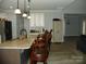 Well-lit kitchen with a granite counter island, pendant lighting, and an open layout to the living room at 128 Summerlake Dr, New London, NC 28127