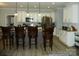Bright kitchen with pendant lights over the island, white cabinets, and stainless steel appliances at 128 Summerlake Dr, New London, NC 28127