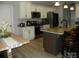 Modern kitchen featuring white cabinets, stainless steel appliances, and a spacious center island at 128 Summerlake Dr, New London, NC 28127