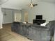 Spacious living room featuring neutral walls, a ceiling fan, and carpet, creating a cozy atmosphere at 128 Summerlake Dr, New London, NC 28127