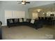 Bright and open living room with a large sectional sofa and open view of the modern kitchen at 128 Summerlake Dr, New London, NC 28127