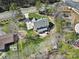 Aerial view of the backyard featuring a patio, fire pit, and seating area, backing onto mature trees and landscaping at 16709 Mckee Rd, Charlotte, NC 28278