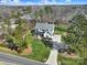 Aerial view of a beautifully landscaped property with a large home, mature trees, and a circular driveway at 16709 Mckee Rd, Charlotte, NC 28278