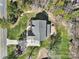 Aerial view of a well-maintained property highlighting the backyard, patio, landscaping, and surrounding greenery at 16709 Mckee Rd, Charlotte, NC 28278
