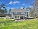 Expansive backyard showcasing a covered patio, lush lawn, fire pit and an outdoor dining area with seating at 16709 Mckee Rd, Charlotte, NC 28278