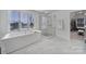Modern bathroom featuring a soaking tub and a glass-enclosed shower with marble tile at 16709 Mckee Rd, Charlotte, NC 28278