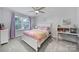 Bright and airy bedroom with a white bed frame, purple curtains and study area at 16709 Mckee Rd, Charlotte, NC 28278
