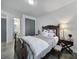 A neutral-toned bedroom features a bed with decorative pillows, side table, and access to an ensuite bathroom at 16709 Mckee Rd, Charlotte, NC 28278