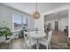 Eat-in kitchen nook with views, light fixture, white table and chairs, and hardwood floors at 16709 Mckee Rd, Charlotte, NC 28278