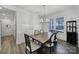 Bright dining room with wood flooring, table, chandelier, and adjacent wine storage cabinet at 16709 Mckee Rd, Charlotte, NC 28278