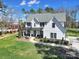Inviting front exterior of a modern farmhouse with a manicured lawn, walkway, and covered front porch at 16709 Mckee Rd, Charlotte, NC 28278