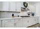 Close up of the stainless steel stovetop, white cabinets, white subway tile and quartz countertops at 16709 Mckee Rd, Charlotte, NC 28278