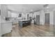 Spacious gourmet kitchen features a large island with barstool seating, stainless steel appliances, and hardwood floors at 16709 Mckee Rd, Charlotte, NC 28278