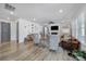 Open concept living room featuring a fireplace, tv, and views to the front entry way and kitchen at 16709 Mckee Rd, Charlotte, NC 28278