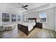 Spacious bedroom featuring neutral walls, a ceiling fan, and two large windows at 16709 Mckee Rd, Charlotte, NC 28278