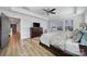 Bright bedroom featuring a ceiling fan, wood floors, and large windows at 16709 Mckee Rd, Charlotte, NC 28278