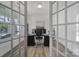 A well-lit office featuring french doors, neutral walls, modern decor, and a workspace with dual monitors at 16709 Mckee Rd, Charlotte, NC 28278