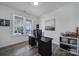A clean office space features neutral walls, crown molding, modern decor, and a large window for natural light at 16709 Mckee Rd, Charlotte, NC 28278