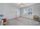 Neutral playroom with lots of light, neutral carpet, and space for toys at 16709 Mckee Rd, Charlotte, NC 28278