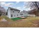 Back of house with a turf area, deck, and a shed in the backyard at 2444 Fabyan Ln, Charlotte, NC 28262