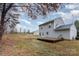 Back of house with a green turf and a deck in the backyard at 2444 Fabyan Ln, Charlotte, NC 28262