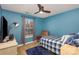 Cozy bedroom featuring a blue accent wall, comfortable bed, and natural light from the window at 2444 Fabyan Ln, Charlotte, NC 28262