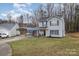 Well-maintained two-story home with a covered parking area and green lawn at 2444 Fabyan Ln, Charlotte, NC 28262