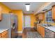 Eat-in kitchen featuring stainless steel appliances, wood-look flooring, and warm colored walls at 2444 Fabyan Ln, Charlotte, NC 28262