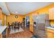 Eat-in kitchen featuring stainless steel appliances, wood-look flooring, and warm colored walls at 2444 Fabyan Ln, Charlotte, NC 28262