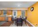 Eat-in kitchen featuring stainless steel appliances, wood-look flooring, and warm colored walls at 2444 Fabyan Ln, Charlotte, NC 28262