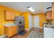 Eat-in kitchen featuring stainless steel appliances, wood-look flooring, and warm colored walls at 2444 Fabyan Ln, Charlotte, NC 28262