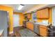 Eat-in kitchen featuring stainless steel appliances, wood-look flooring, and warm colored walls at 2444 Fabyan Ln, Charlotte, NC 28262