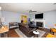 Comfortable living room with a fireplace, TV, and open kitchen view at 2444 Fabyan Ln, Charlotte, NC 28262
