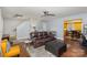 Inviting living room with a plush brown leather sofa and a modern ceiling fan at 2444 Fabyan Ln, Charlotte, NC 28262
