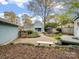 Serene backyard with a bench, patio set, and meticulously kept landscaping at 253 Misenheimer Nw Dr, Concord, NC 28025