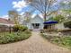 Quaint backyard with gravel path, patio seating area, lush landscaping, and privacy fence at 253 Misenheimer Nw Dr, Concord, NC 28025